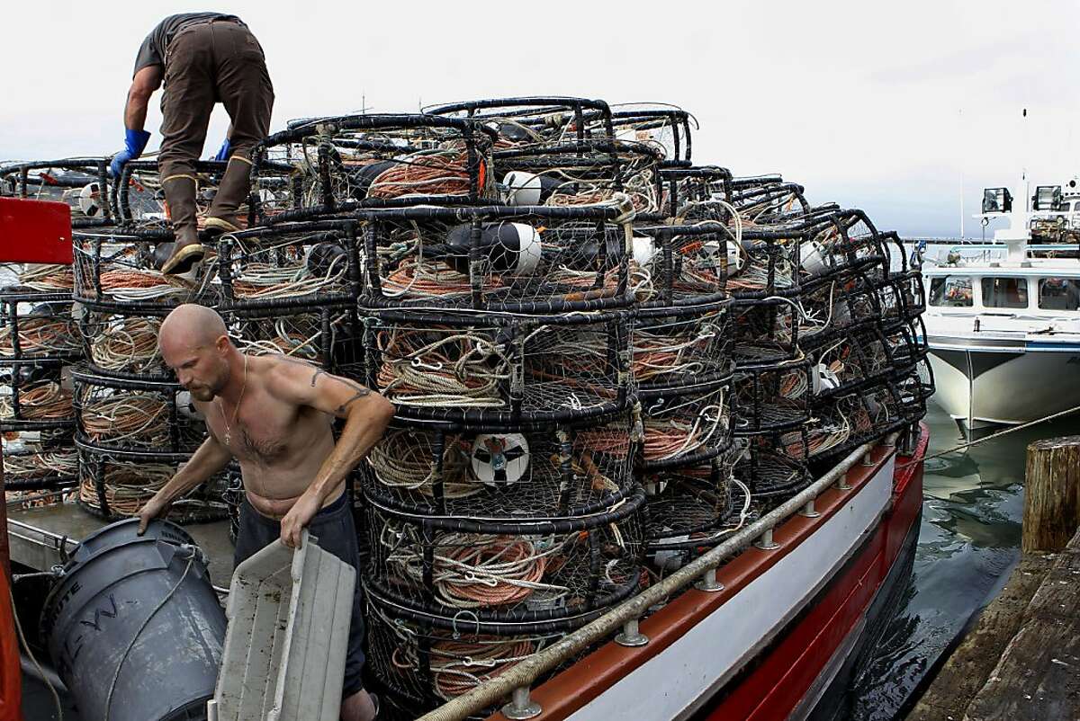 Roger Rowland, (top) and Steve Nielsen load the "AL-W" full of crab pots along Pier 45 in San Francisco Ca., on Thursday Nov. 14, 2013. Crab fisherman fill their boats with crab pots in preparation of crab season which opens tomorrow November 15.
