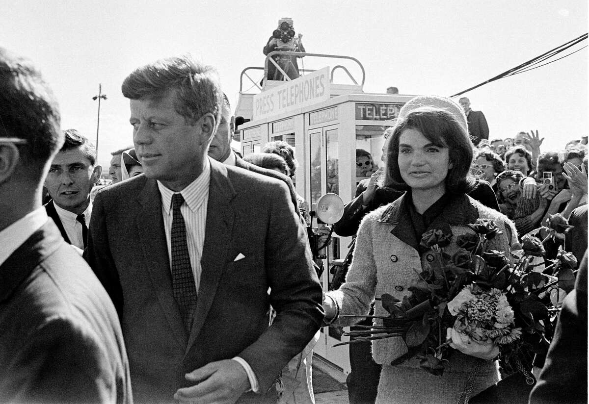 FILE - In this Nov. 22, 1963 file photo, President John F. Kennedy and his wife, Jacqueline Kennedy, arrive at Love Field airport in Dallas, as a television camera, above, follows them. More than a dozen new documentary and information specials are among the crop of TV commemorations pegged to this half-century mark of a weekend when, as viewers will be reminded again and again, everything changed. (AP Photo/File) ORG XMIT: NYET405