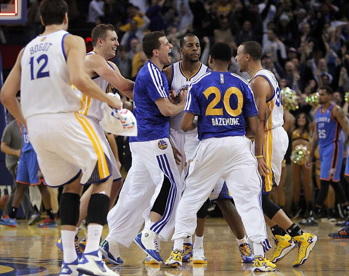 Andre Iguodala celebrates with teammates after he hit the game-winning shot as time expired to give the Warriors a 116-115 win. The Golden State Warriors played the Oklahoma City Thunder at Oracle Arena in Oakland, Calif., on Thursday, November 14, 2013.