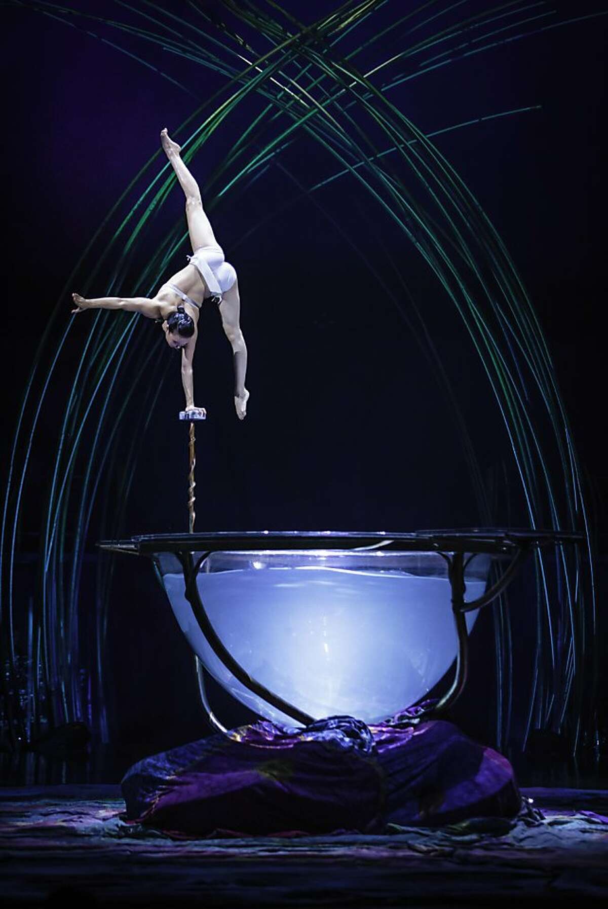 Miranda (Iuliia Mykhailova) discovers herself in her reflection in a challenging hand-balancing routine in Cirque du Soleil's "Amaluna"