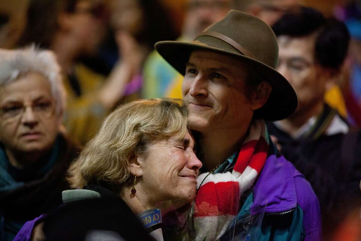 Debbie and Karl Fleischman, parents of Sasha Fleishman, 18, who was burned on an AC Transit bus by another teen, react to the overwhelming support shown during a march in Oakland, Calif., Thursday, November 14, 2013.