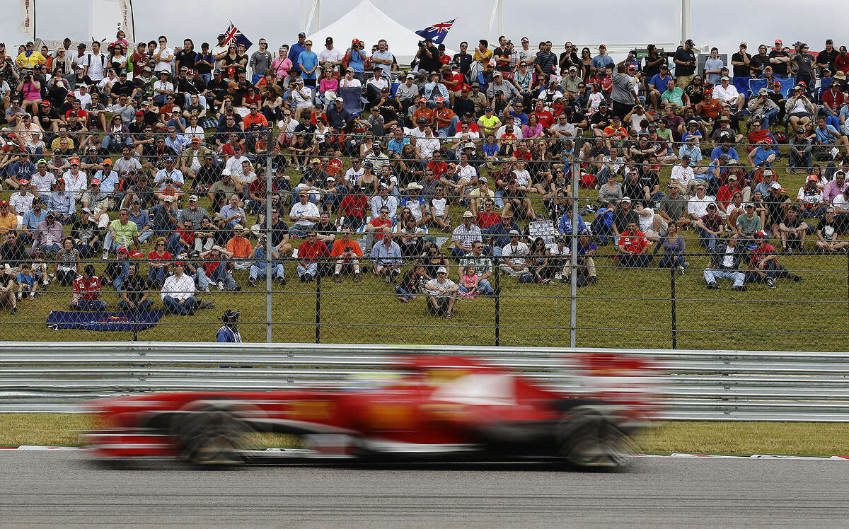 Fans at the Circuit of the Americas watch cars whiz past during practice for today's Formula One race in Austin. Sebastian Vettel, Mark Webber and Romain Grosjean will be the top three starters.