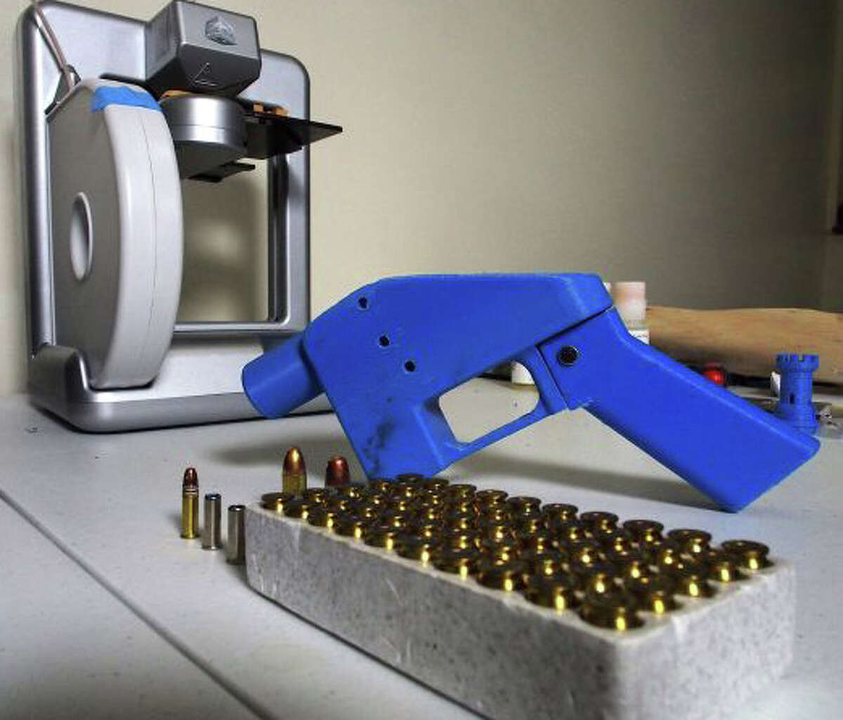 A Liberator pistol appears next to the 3D printer on which its components were made. The single-shot handgun is the first firearm that can be made entirely with plastic components forged with a 3D printer and computer-aided design (CAD) files downloaded from the Internet.