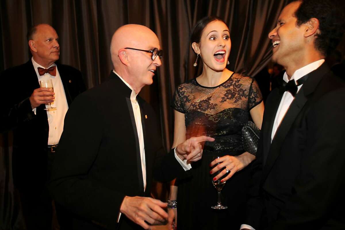 Melanie Hamrick, center, and Jose Carreno, right, laugh as they meet Orlando Diaz-Azcuy , second from left, with Diaz-Azcuy's partner, John Capo standing at left, during the cocktail reception for the Artistic Director Jose Manuel Carreno with Ballet San Jose as part of a gala evening and performance November 16, 2013 at the San Jose Center for Performing Arts in San Jose, Calif.