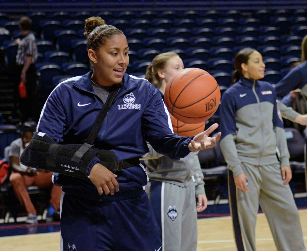 Sidelined by an injury, Connecticut's Kaleena Mosqueda-Lewis (23) catches balls for teammates before an NCAA college basketball game against Penn State, Sunday, Nov. 17, 2013, in State College, Pa.