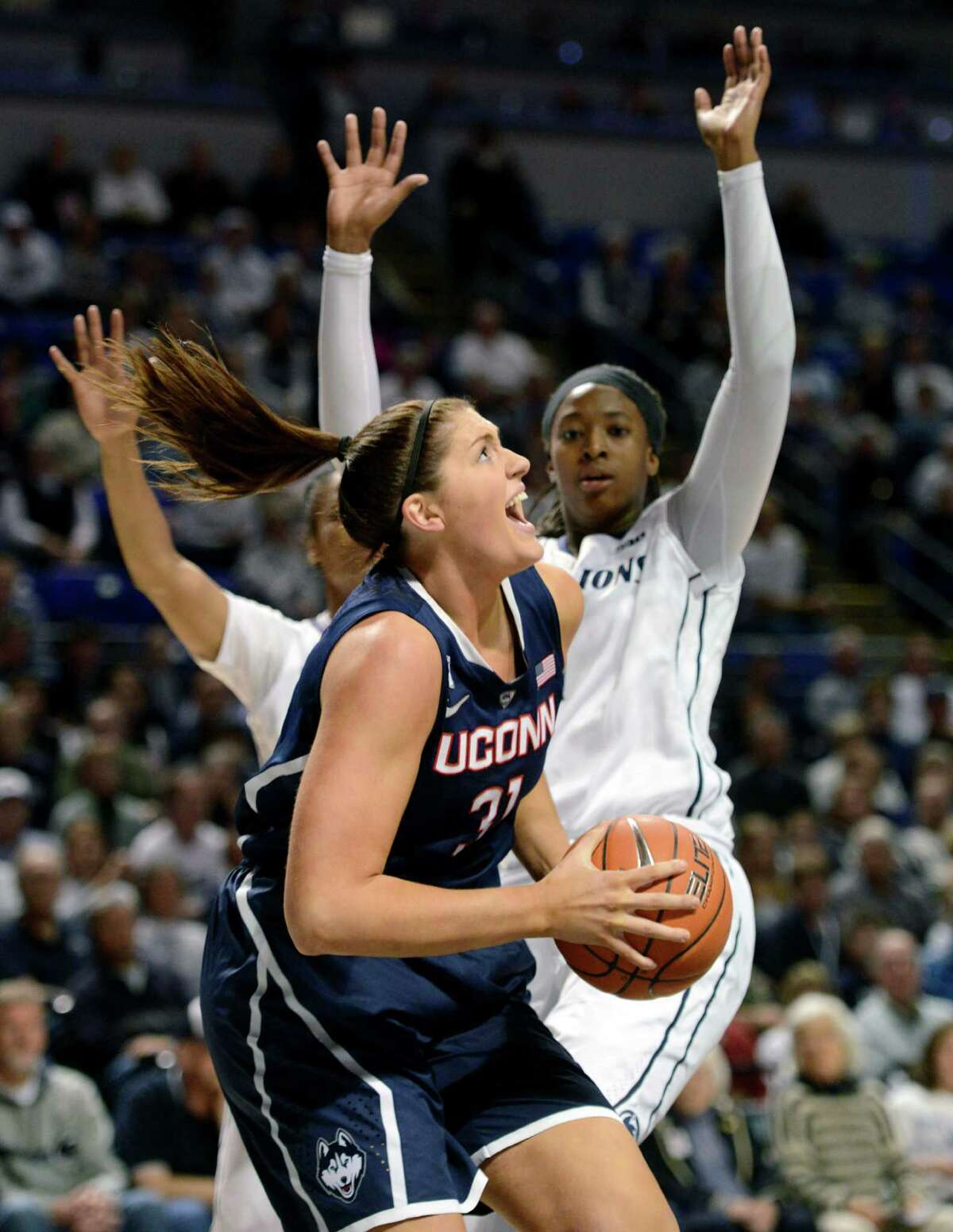 Sidelined by an injury, Connecticut's Kaleena Mosqueda-Lewis (23) catches balls for teammates before an NCAA college basketball game against Penn State, Sunday, Nov. 17, 2013, in State College, Pa.