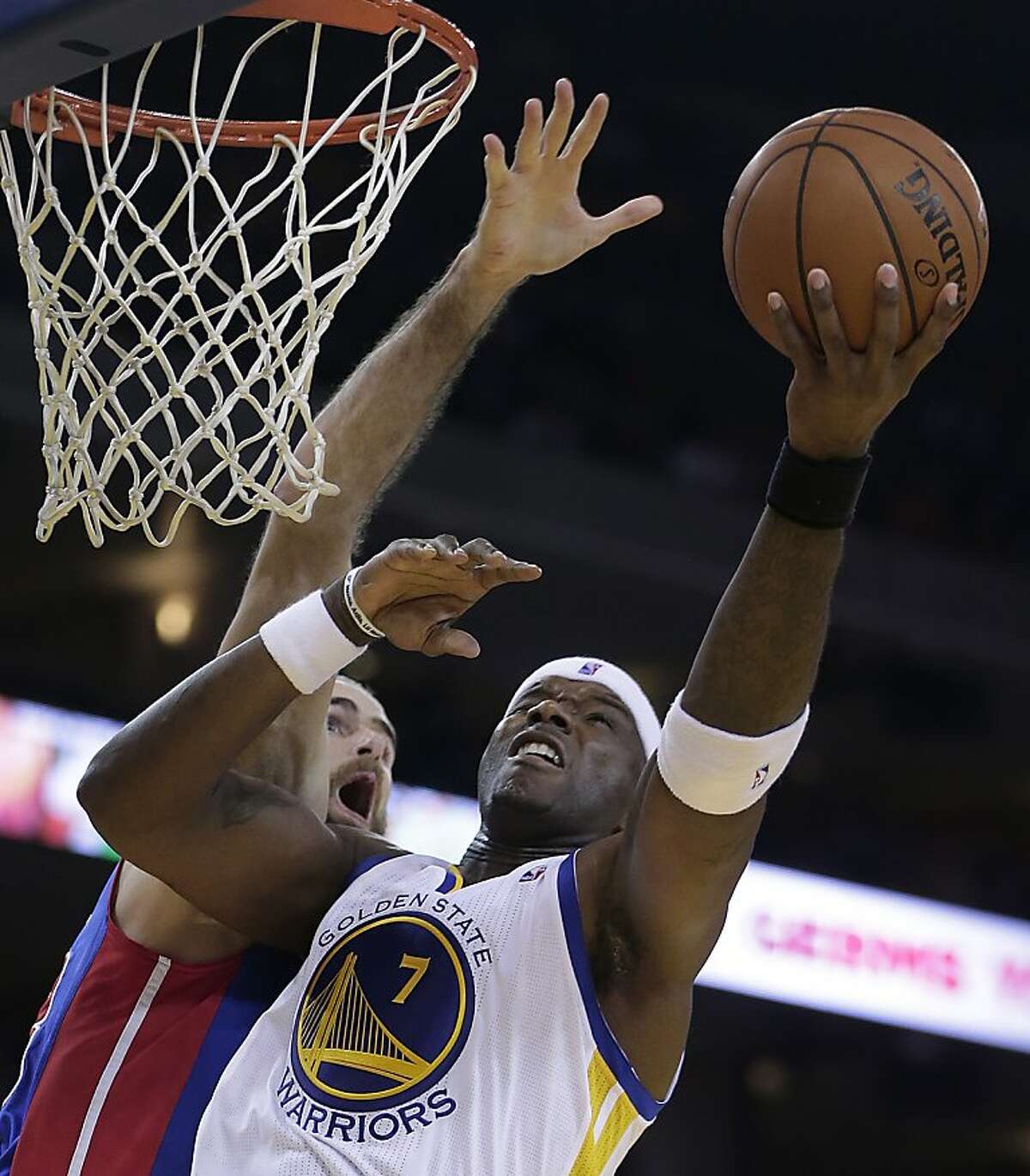 Golden State Warriors' Jermaine O'Neal, right, lays up a shot over Detroit Pistons' Luigi Datome during the second half of an NBA basketball game Tuesday, Nov. 12, 2013, in Oakland, Calif. (AP Photo/Ben Margot)
