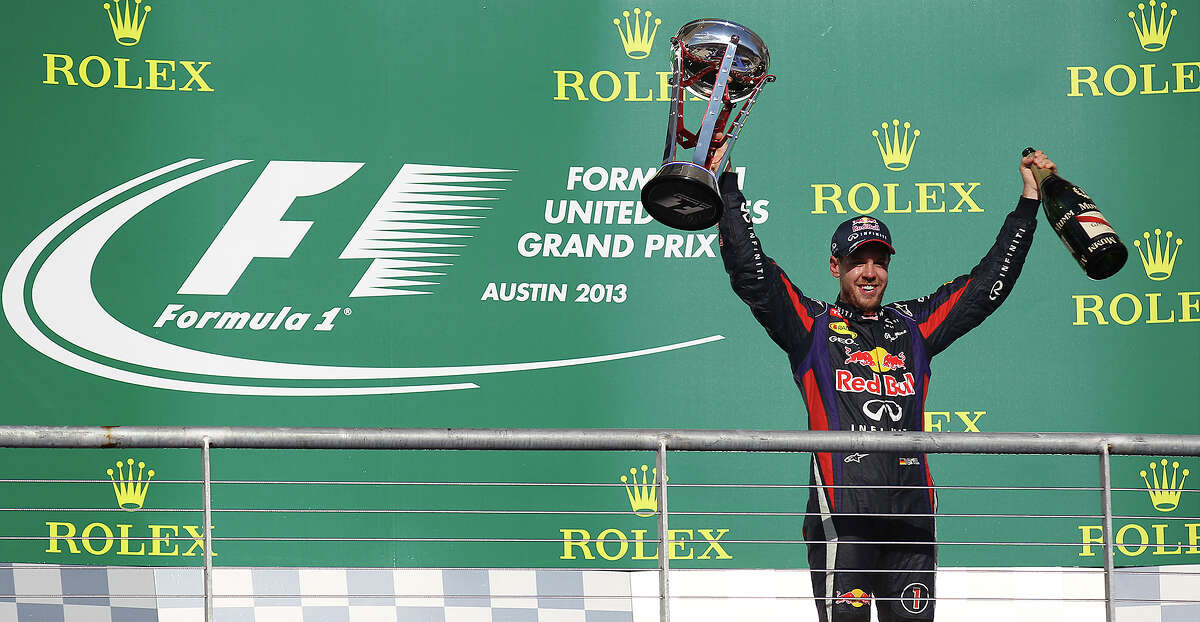 2013 USGP winner and current World Champion Sebastian Vettel acknowledges the crowd after The Formula One United States Grand Prix at the Circuit of the Americas near Austin, Texas on Sunday, Nov. 17, 2013. Vettel finished first followed by Lotus F1's Romain Grosjean and in third was Vettel's teammate, Mark Webber.