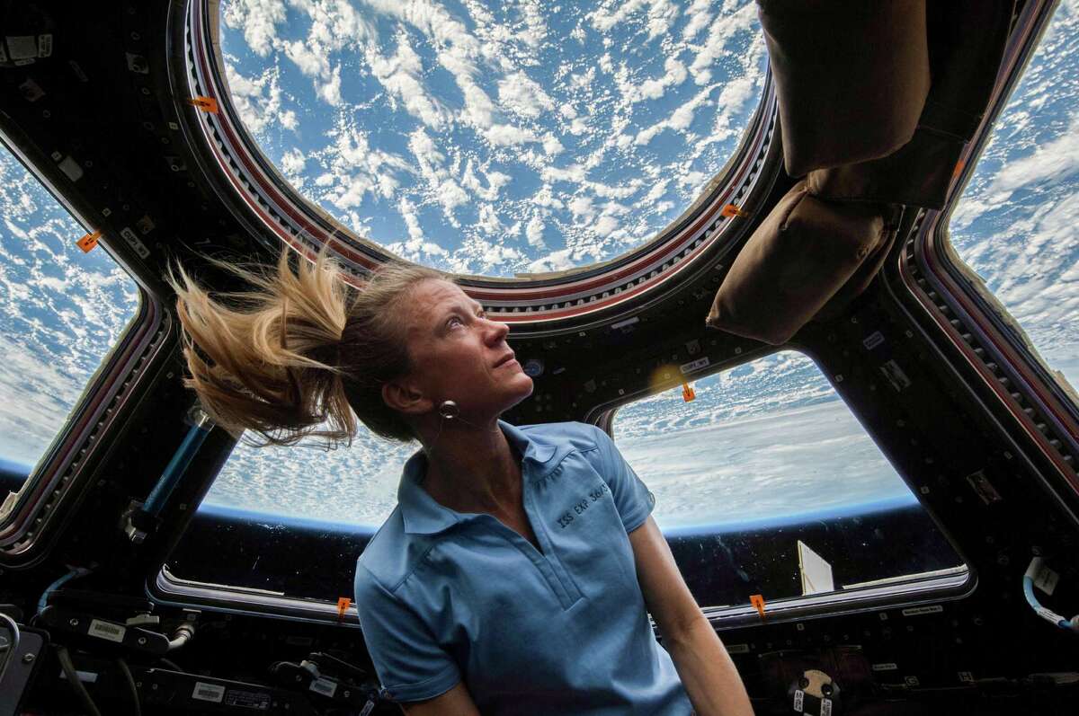 NASA astronaut Karen Nyberg enjoys the view of Earth from the windows in the Cupola of the International Space Station during her Expedition 37 mission in 2013.