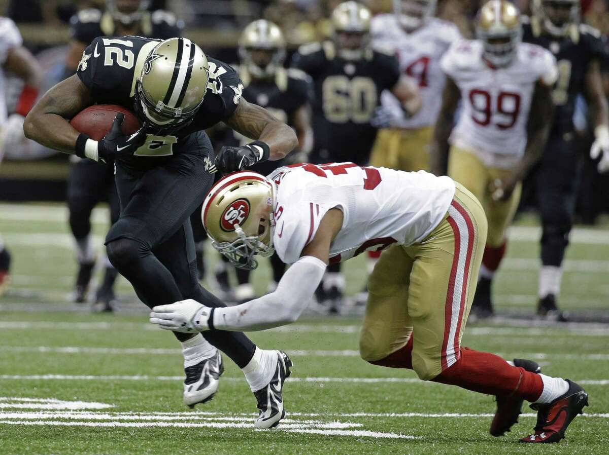 Marques Colston (left) hauls in a catch over 49ers cornerback Carlos Rogers to set up Garrett Hartley's game-winning field goal. Colston became the Saints' all-time leader in yards receiving with 7,923.