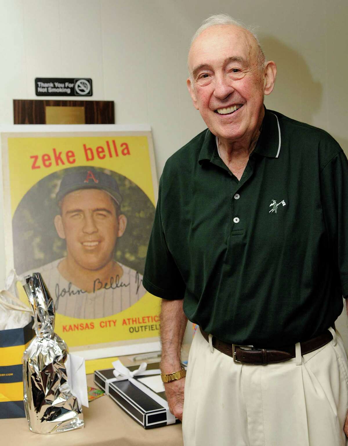 Cos Cob's John "Zeke" Bella, former outfielder for the New York Yankees and Kansas City Athletics, stands in front of a replica of his baseball card during his 80th birthday party with friends and family at the St. Lawrence Club in Cos Cob back in August of 2010.