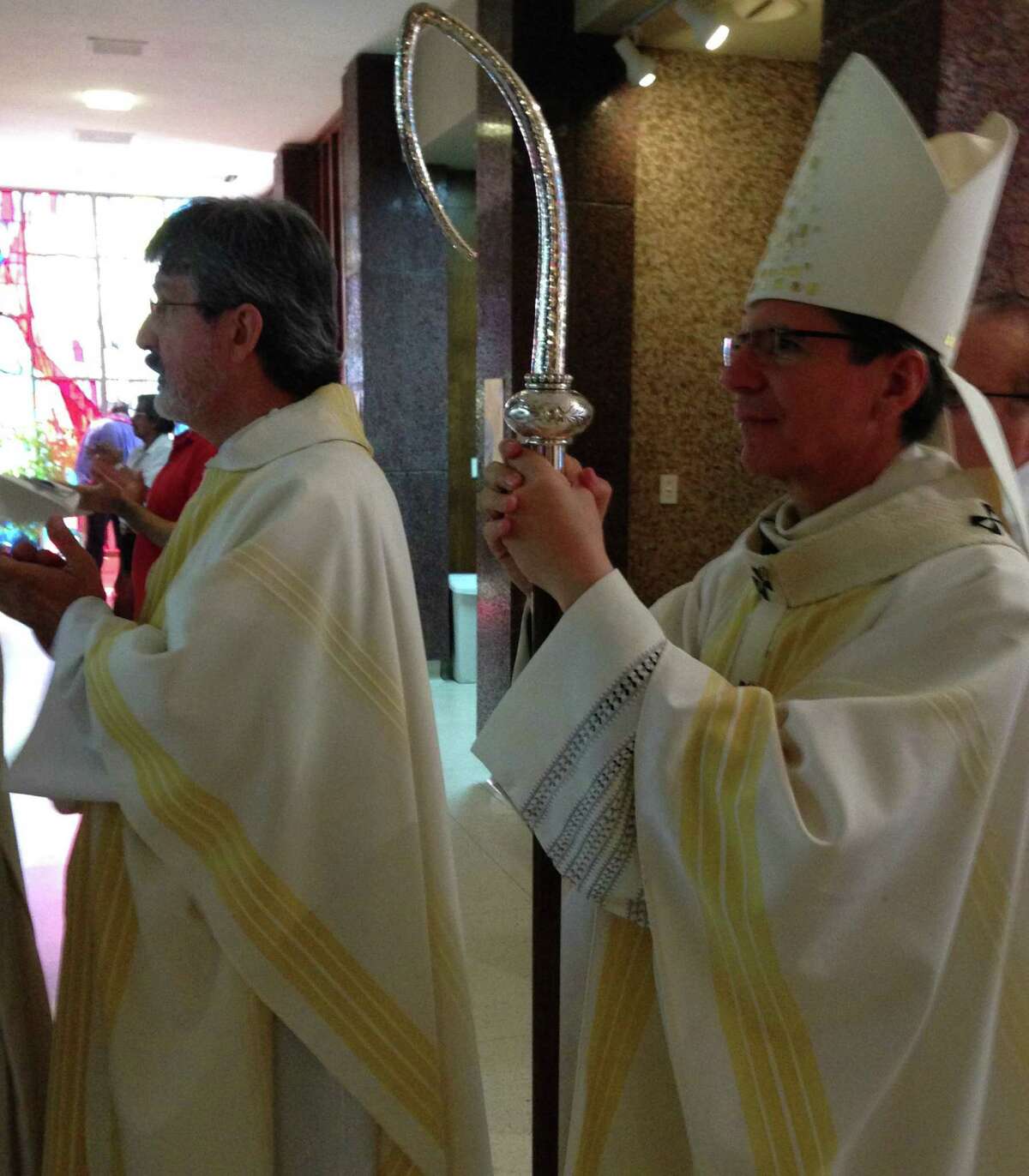 Rev. Norman Ermis, St. Margaret Mary's pastor, left, and Archbishop Gustavo Garcia-Siller lead the procession at the Mass celebrating the rededication of St. Margaret Mary Catholic Church.