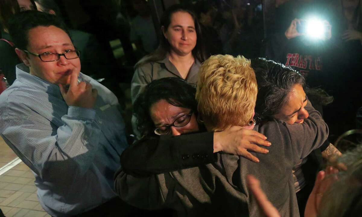 Cassandra Rivera, right, and Elizabeth Ramirez, are embraced by Gloria Herrera, Elizabeth's mother as Kristie Mayhugh, left, and Anna Vasquez, above exit Bexar Countly Jail. Rivera, Ramirez and Mayhugh were released from from prison today Monday, Nov. 18, 2013. Anna Vasque, was released on parole from prison just over a year ago.