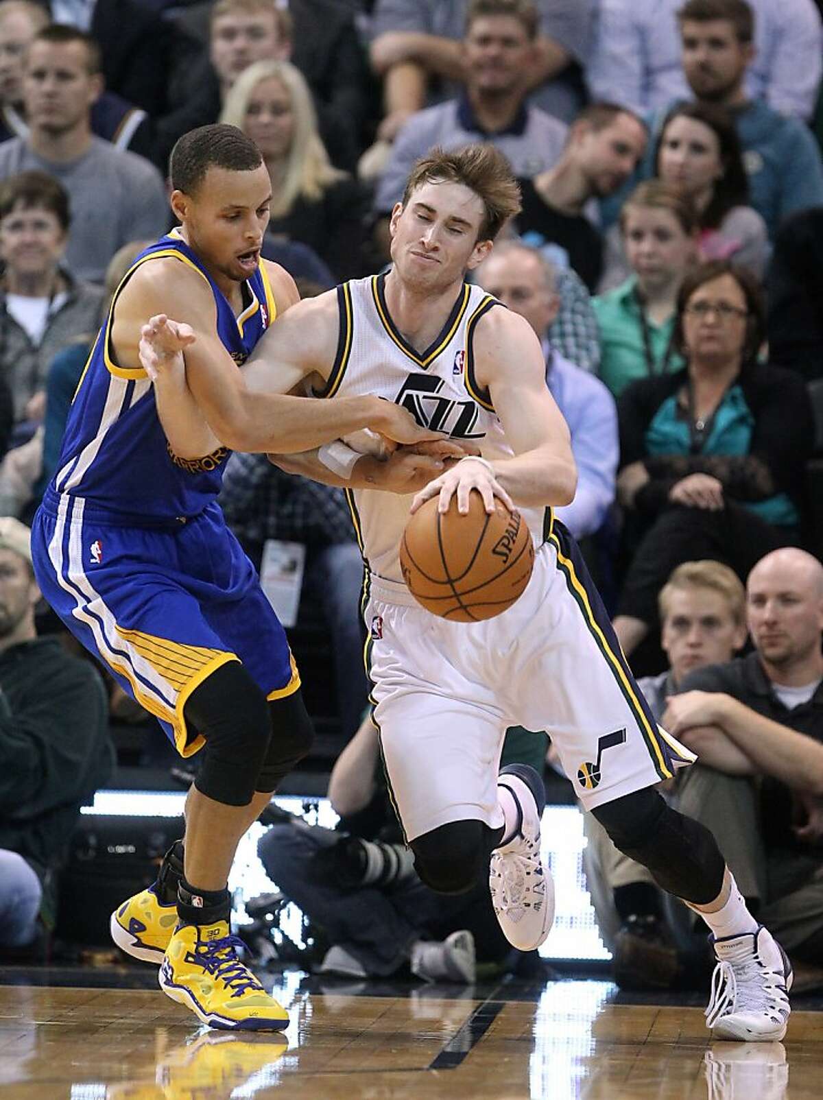 Golden State Warriors' Stephen Curry, left, fouls Utah Jazz's Gordon Hayward in the second quarter during an NBA basketball game Monday, Nov. 18, 2013, in Salt Lake City. (AP Photo/Rick Bowmer)