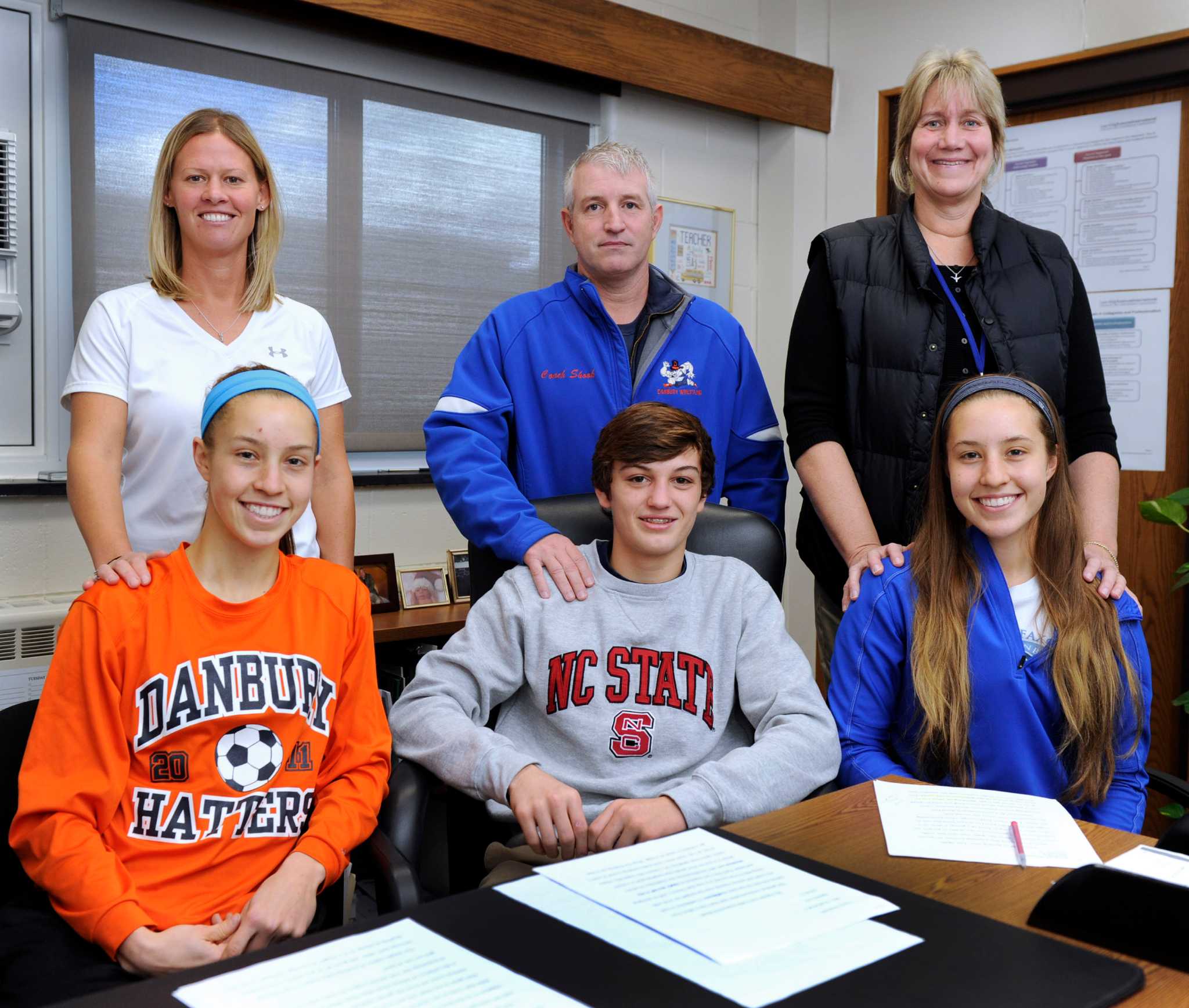 Three Danbury High athletes sign with Division I programs
