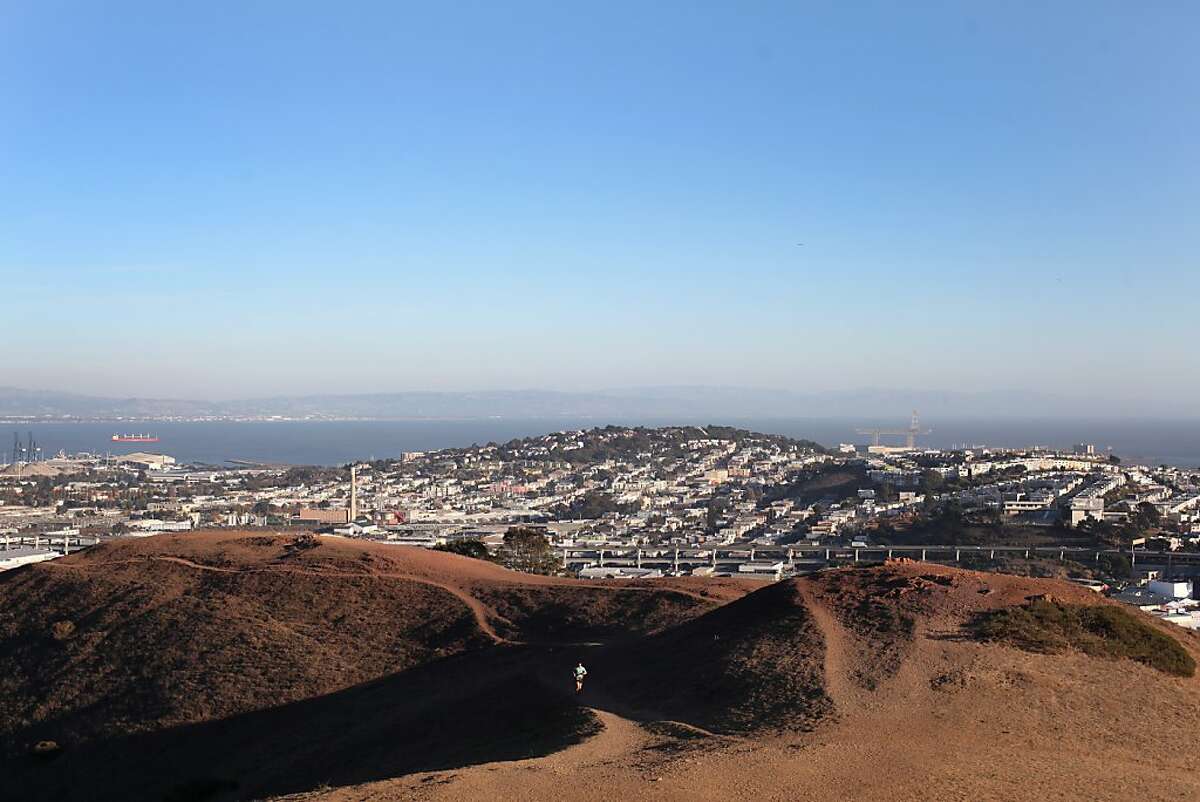 A runner emerges from shade at Bernal Heights Park on November 15, 2013 in San Francisco, Calif.