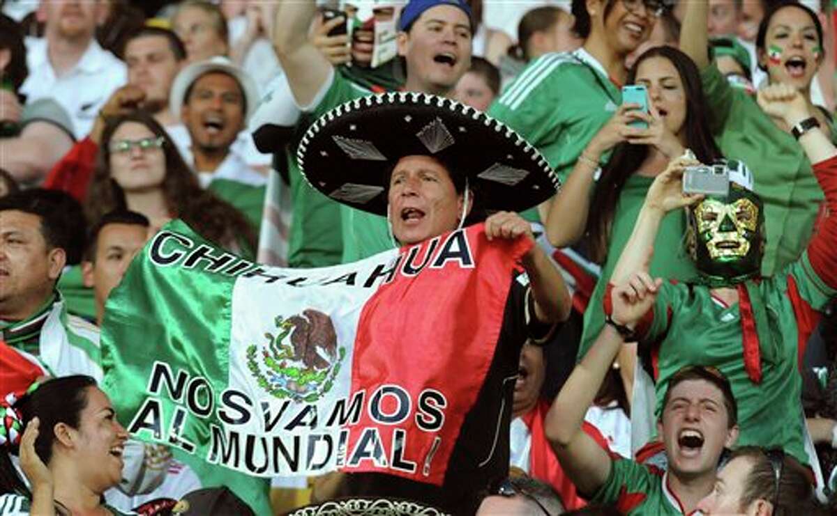 Mexican fans cheer in the World Cup soccer qualifier against New Zealand at Westpac Stadium in Wellington, New Zealand, Wednesday, Nov. 20, 2013. (AP Photo/SNPA, John Cowpland) NEW ZEALAND OUT