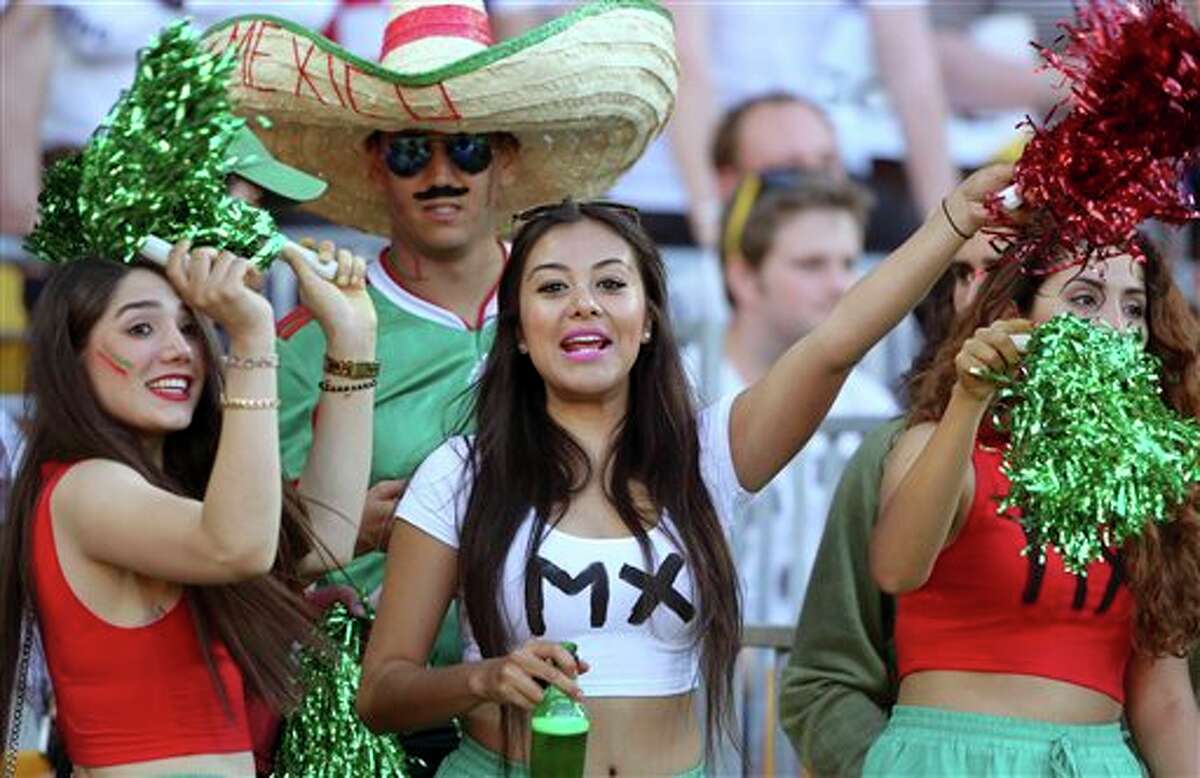 Mexican fans celebrate a goal in the World Cup soccer qualifier against New Zealand at Westpac Stadium in Wellington, New Zealand, Wednesday, Nov. 20, 2013. (AP Photo/SNPA, John Cowpland) NEW ZEALAND OUT