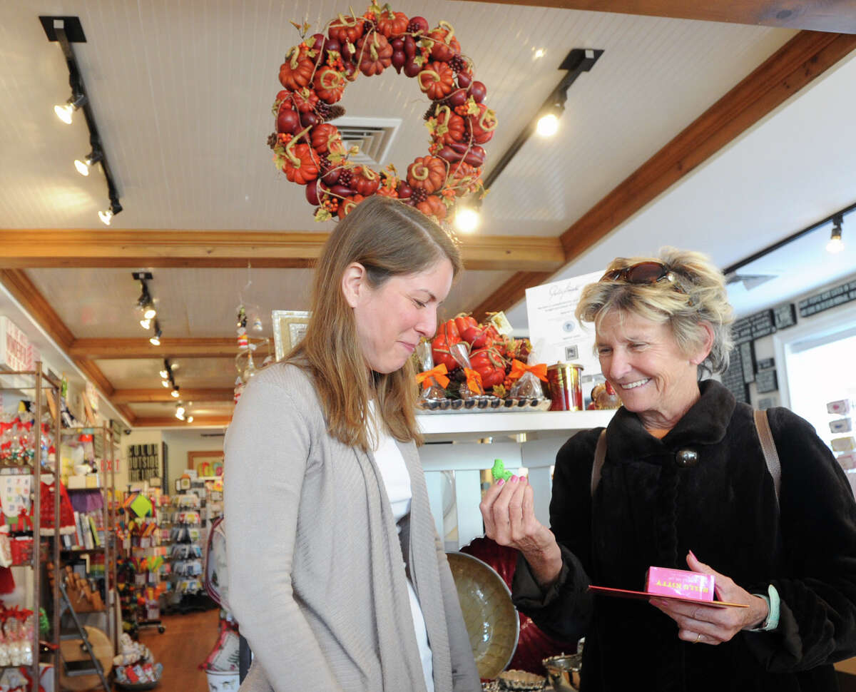 At left, Sonia Sotire Malloy, owner of the Splurge store, speaks with customer Carol Gray of Greenwich who was shopping for holiday gifts inside the store at 39 Lewis Street, Greenwich, Wednesday, Nov. 20, 2013.