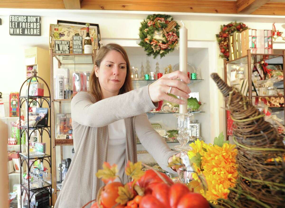 Sonia Sotire Malloy, owner of the Splurge store, sets-up a Thanksgiving display inside the store at 39 Lewis Street, Greenwich, Wednesday, Nov. 20, 2013.