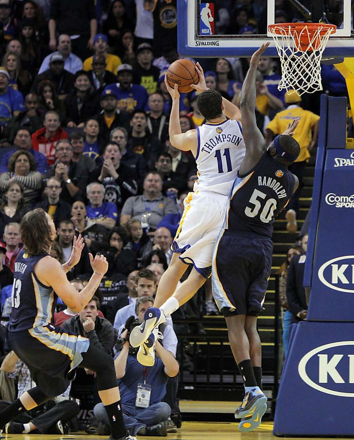 Klay Thompson shoots over Zach Randolph (50) in the second half. The Golden State Warriors played the Memphis Grizzlies at Oracle Arena in Oakland, Calif., on Wednesday, November 20, 2013. The Grizzlies won 88-81 in overtime.