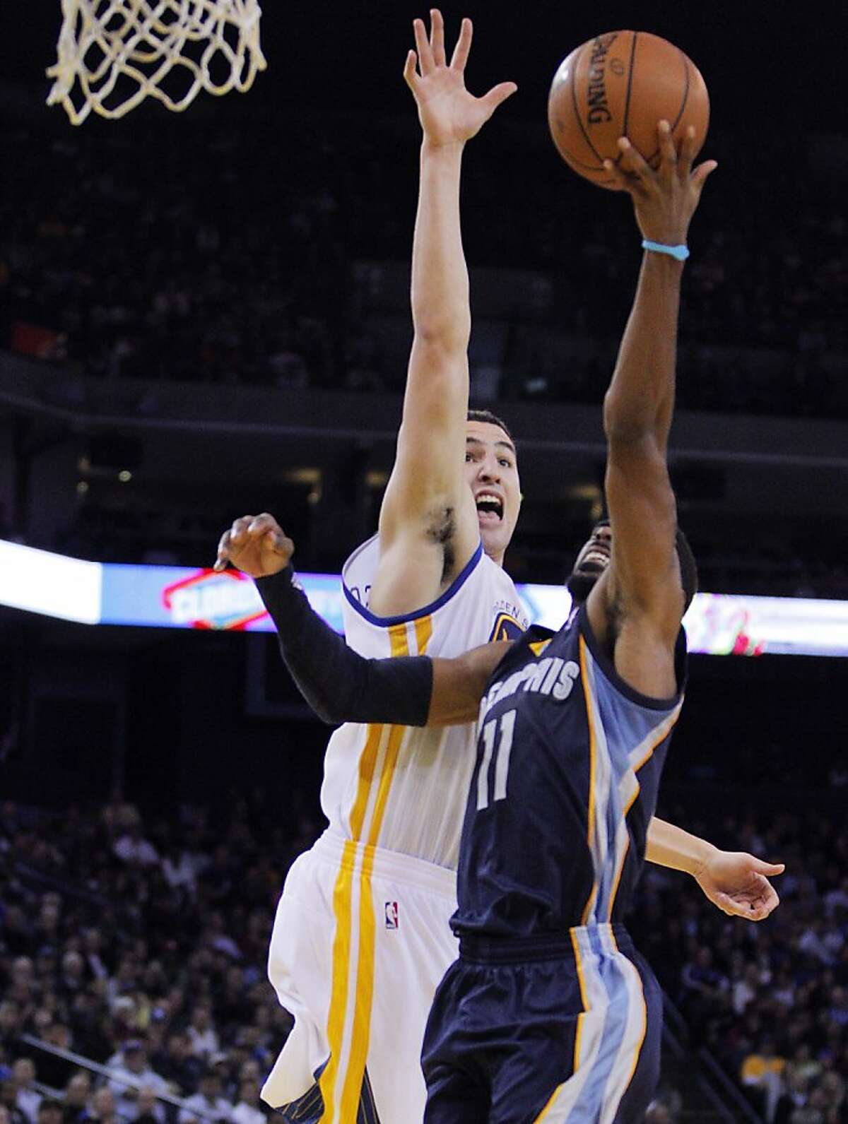 Klay Thompson guards against Mike Conley in the second half. The Golden State Warriors played the Memphis Grizzlies at Oracle Arena in Oakland, Calif., on Wednesday, November 20, 2013. The Grizzlies won 88-81 in overtime.