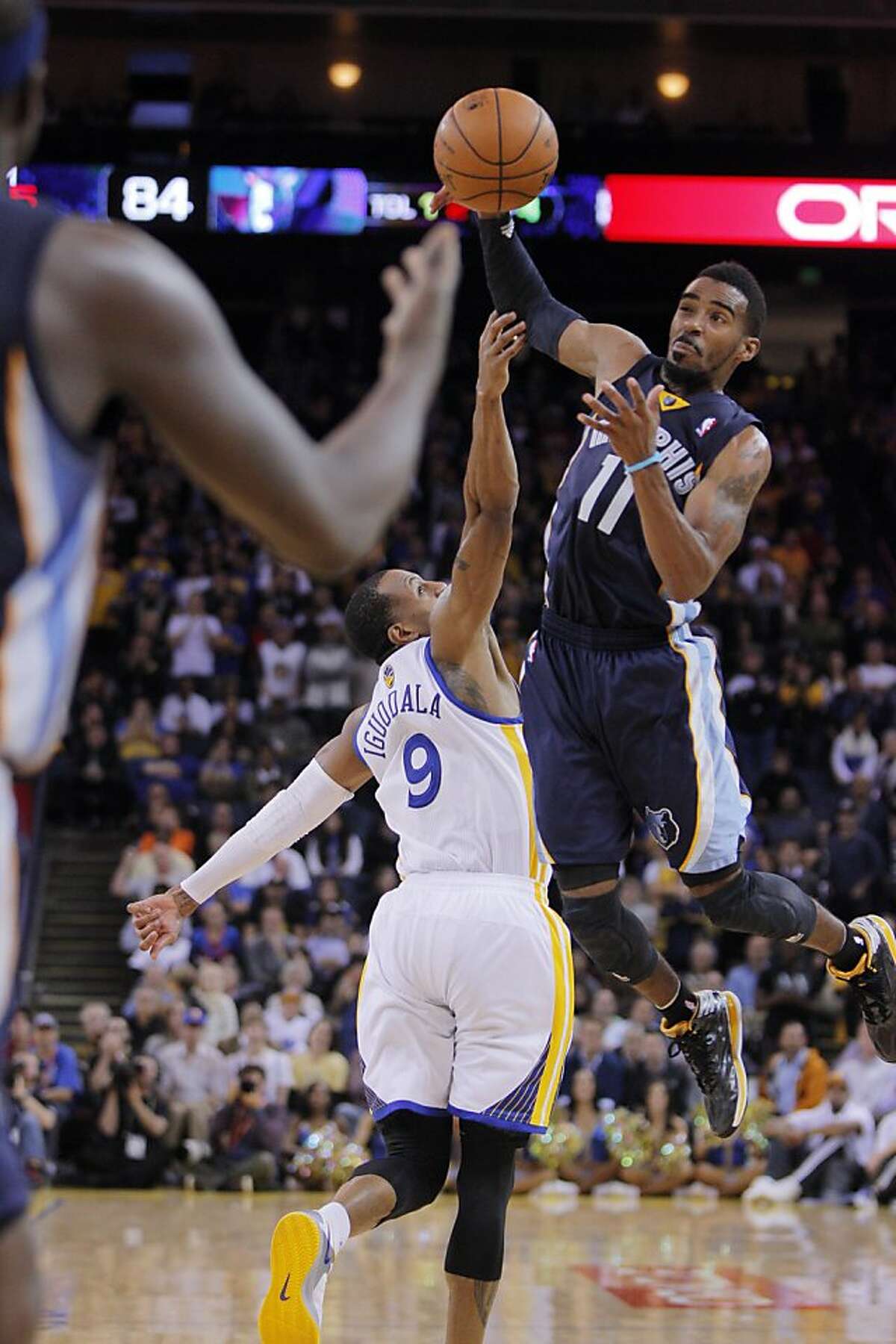 Mike Conley (11) gets up for a tipped pass over Andre Iguodala in the second half. The Golden State Warriors played the Memphis Grizzlies at Oracle Arena in Oakland, Calif., on Wednesday, November 20, 2013. The Grizzlies won 88-81 in overtime.