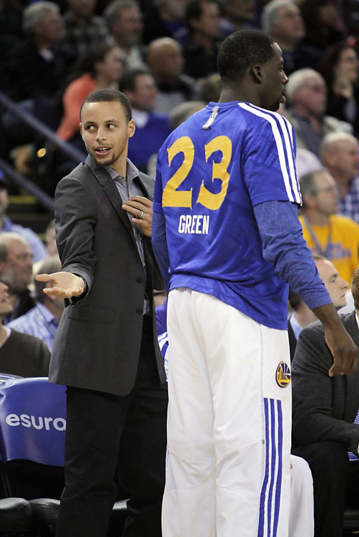 Stephen Curry gestures on the bench after Klay Thompson hit a three-point shot in the first half. The Golden State Warriors played the Memphis Grizzlies at Oracle Arena in Oakland, Calif., on Wednesday, November 20, 2013