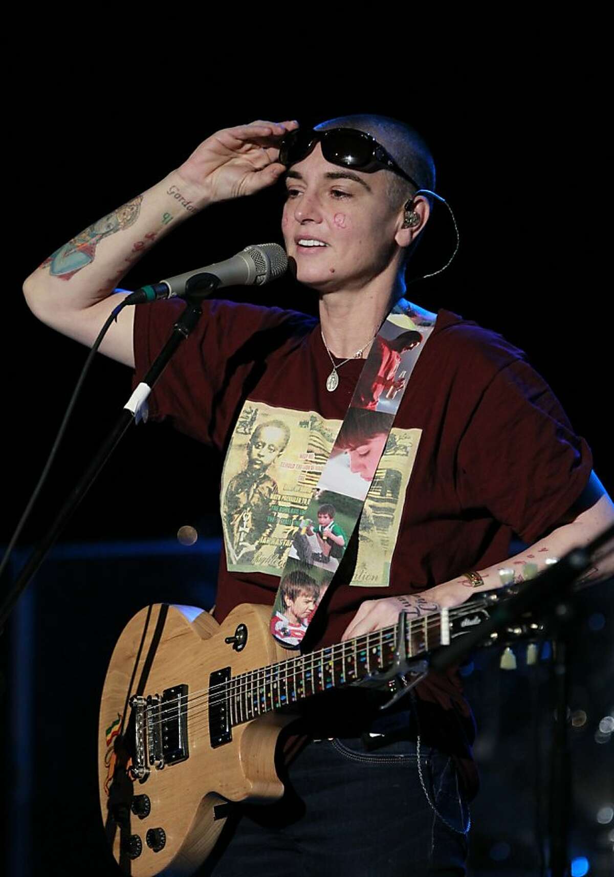 In this photo taken Tuesday, Nov. 12, 2013, Sinead O'Connor performs at the Riviera Theatre in North Tonawanda, N.Y. (AP Photo/The Buffalo News, Harry Scull Jr.) TV OUT; MAGS OUT; MANDATORY CREDIT; BATAVIA DAILY NEWS OUT; DUNKIRK OBSERVER OUT; JAMESTOWN POST-JOURNAL OUT; LOCKPORT UNION-SUN JOURNAL OUT; NIAGARA GAZETTE OUT; OLEAN TIMES-HERALD OUT; SALAMANCA PRESS OUT; TONAWANDA NEWS OUT