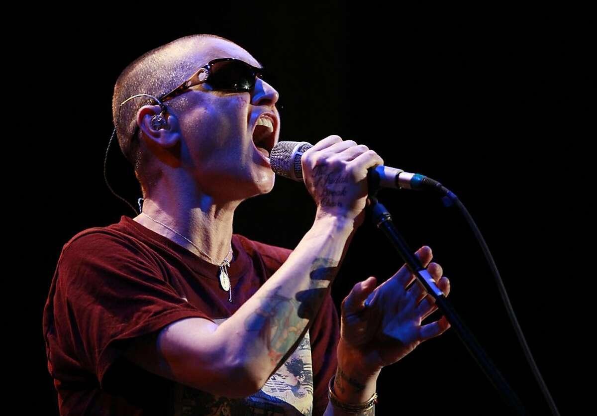 In this photo taken Tuesday, Nov. 12, 2013, Sinead O'Connor performs at the Riviera Theatre in North Tonawanda, N.Y. (AP Photo/The Buffalo News, Harry Scull Jr.) TV OUT; MAGS OUT; MANDATORY CREDIT; BATAVIA DAILY NEWS OUT; DUNKIRK OBSERVER OUT; JAMESTOWN POST-JOURNAL OUT; LOCKPORT UNION-SUN JOURNAL OUT; NIAGARA GAZETTE OUT; OLEAN TIMES-HERALD OUT; SALAMANCA PRESS OUT; TONAWANDA NEWS OUT