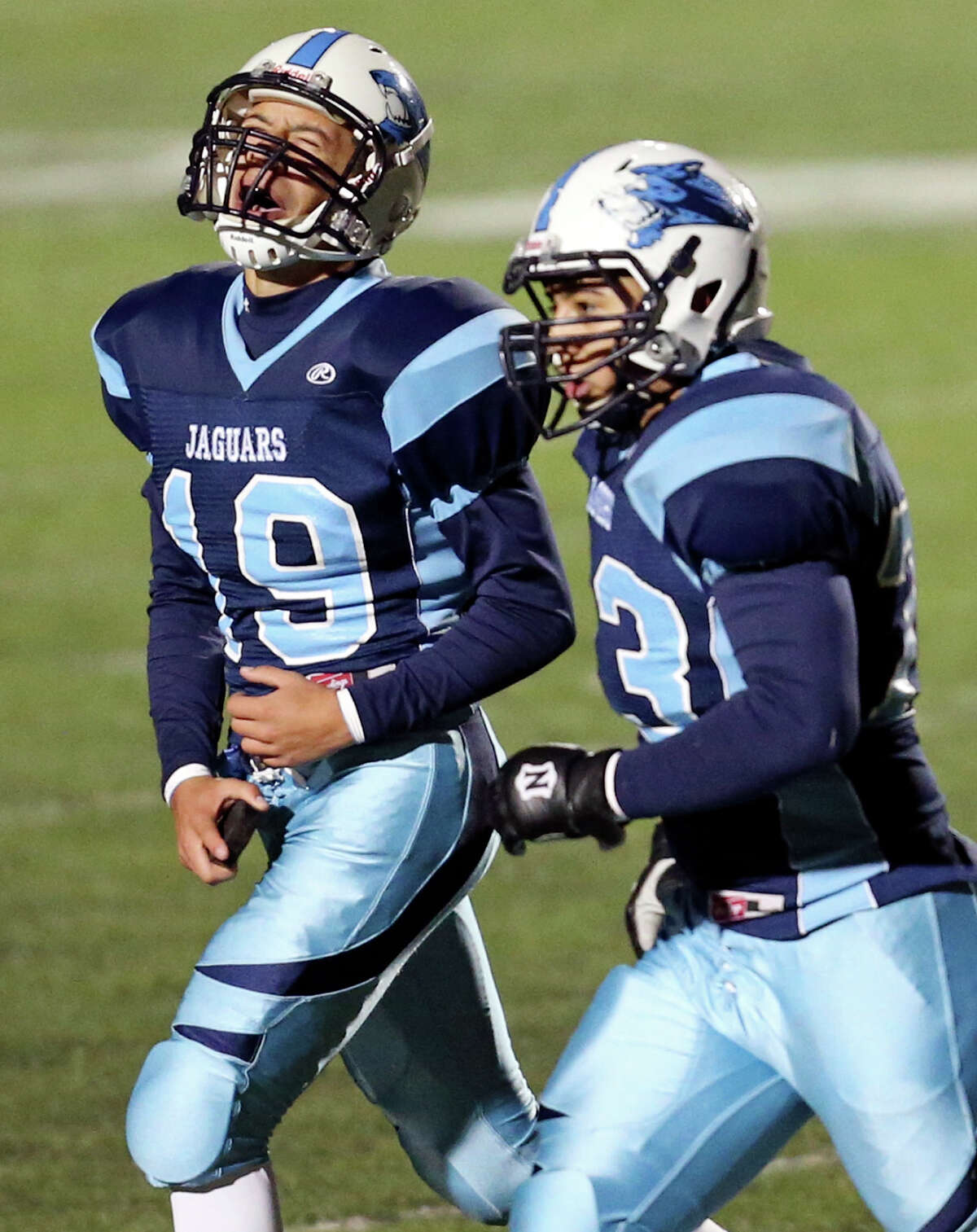 Johnson's Zachary Elder (left) celebrates as he walks off the field with teammate Nick Vidal after making a field goal late in second half action of their Class 5A Division II area playoff game against Brandeis Friday Nov. 22, 2013 at Heroes Stadium. Johnson won 23-17 in overtime.