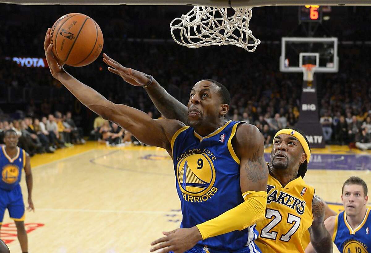 Golden State Warriors forward Andre Iguodala, left, puts up a shot as Los Angeles Lakers center Jordan Hill defends during the first half of an NBA basketball game, Friday, Nov. 22, 2013, in Los Angeles. (AP Photo/Mark J. Terrill)