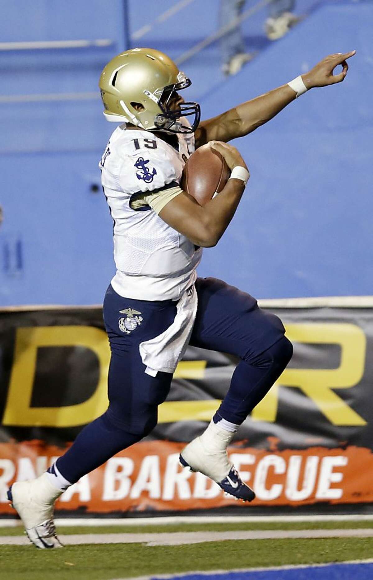 Navy quarterback Keenan Reynolds celebrates as he score the game-winning touchdown in triple overtime for a 58-52 win over San Jose State in an NCAA college football game on Friday, Nov. 22, 2013, in San Jose, Calif. N (AP Photo/Marcio Jose Sanchez)