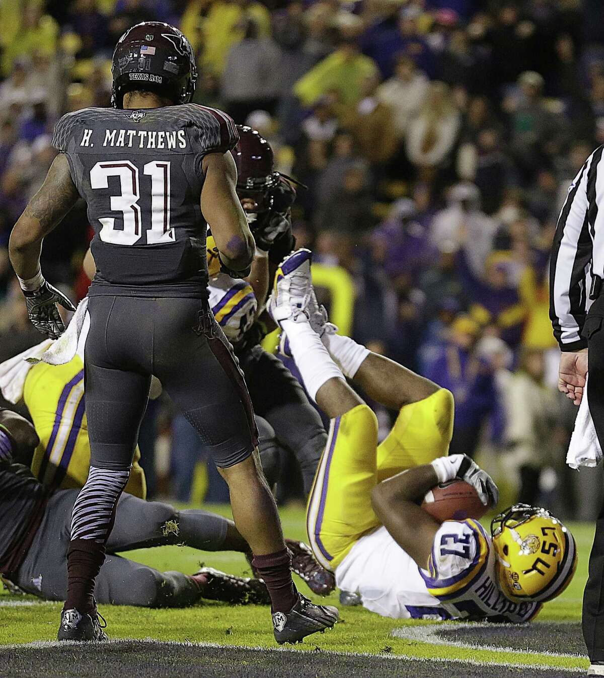 LSU running back Kenny Hilliard (27) dives into the end zone on a rushing touchdown in the second half of an NCAA college football game against Texas A&M in Baton Rouge, La., Saturday, Nov. 23, 2013. LSU won 34-10. (AP Photo/Gerald Herbert)
