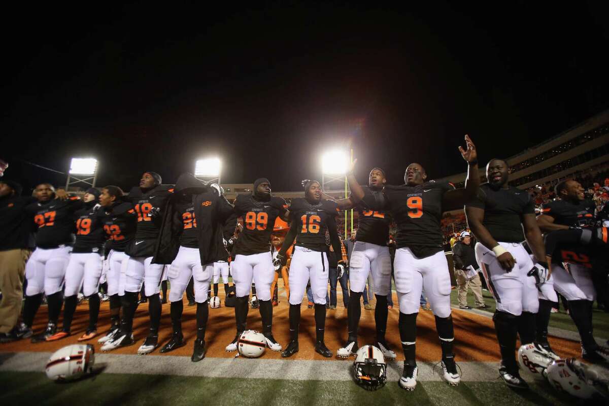 STILLWATER, OK - NOVEMBER 23: The Oklahoma State Cowboys celebrate a 49-17 win against the Baylor Bears at Boone Pickens Stadium on November 23, 2013 in Stillwater, Oklahoma.