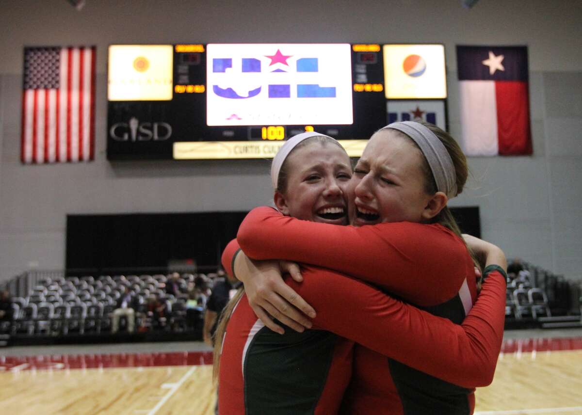 The Woodlands' Rachel Reed (12) and Morgan Eason (5) celebrate after defeating San Antonio Churchill in straight sets to win the Class 5A UIL Volleyball State Championship Saturday, Nov. 23, 2013, in Garland, Texas. The Woodlands became the 18th undefeated volleyball state champion in UIL history since 1967. (AP Photo/ The Courier, Jason Fochtman)