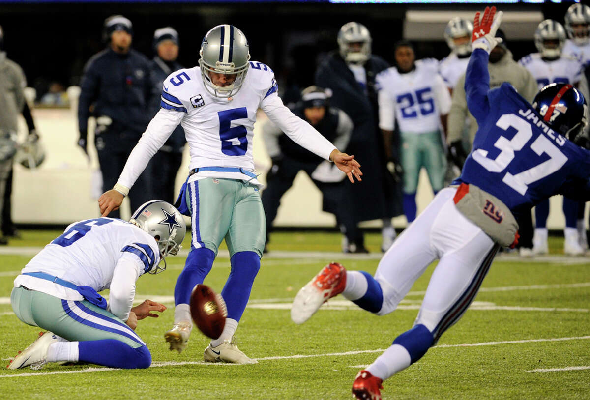 Dallas Cowboys kicker Dan Bailey (5), with Chris Jones holding, kicks a game-winning field goal against the New York Giants during the second half of an NFL football game, Sunday, Nov. 24, 2013, in East Rutherford, N.J. The Cowboys won 24-21. (AP Photo/Bill Kostroun)