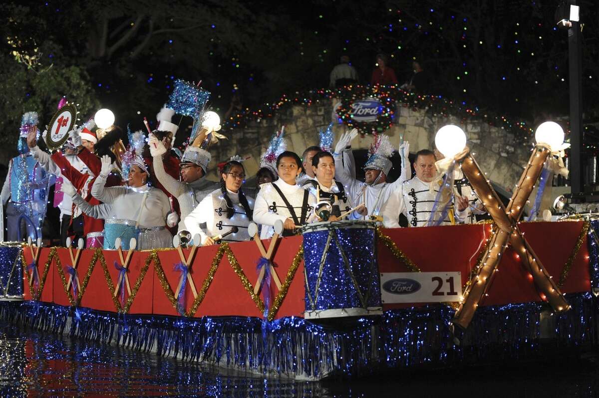 Members of the San Antonio Street Dance and Drum float display their first-place ribbon during the 30th annual Ford Holiday River Parade on the River Walk in San Antonio in 2012.
