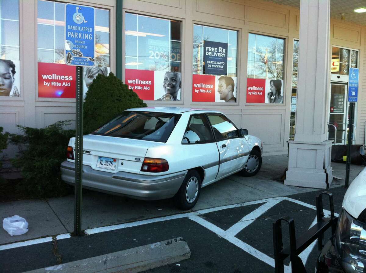 A car struck the Rite Aid pharmacy at 1619 Post Road while firefighters were on scene across the street at a fire reported Monday afteroon at the shopping center at 1580 Post Road.