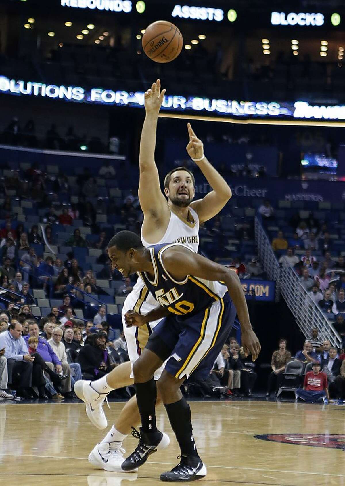 New Orleans Pelicans power forward Ryan Anderson, top, shoots as he draws a foul by Utah Jazz small forward Jeremy Evans (40) in the first half of an NBA basketball game in New Orleans, Wednesday, Nov. 20, 2013. (AP Photo/Gerald Herbert)