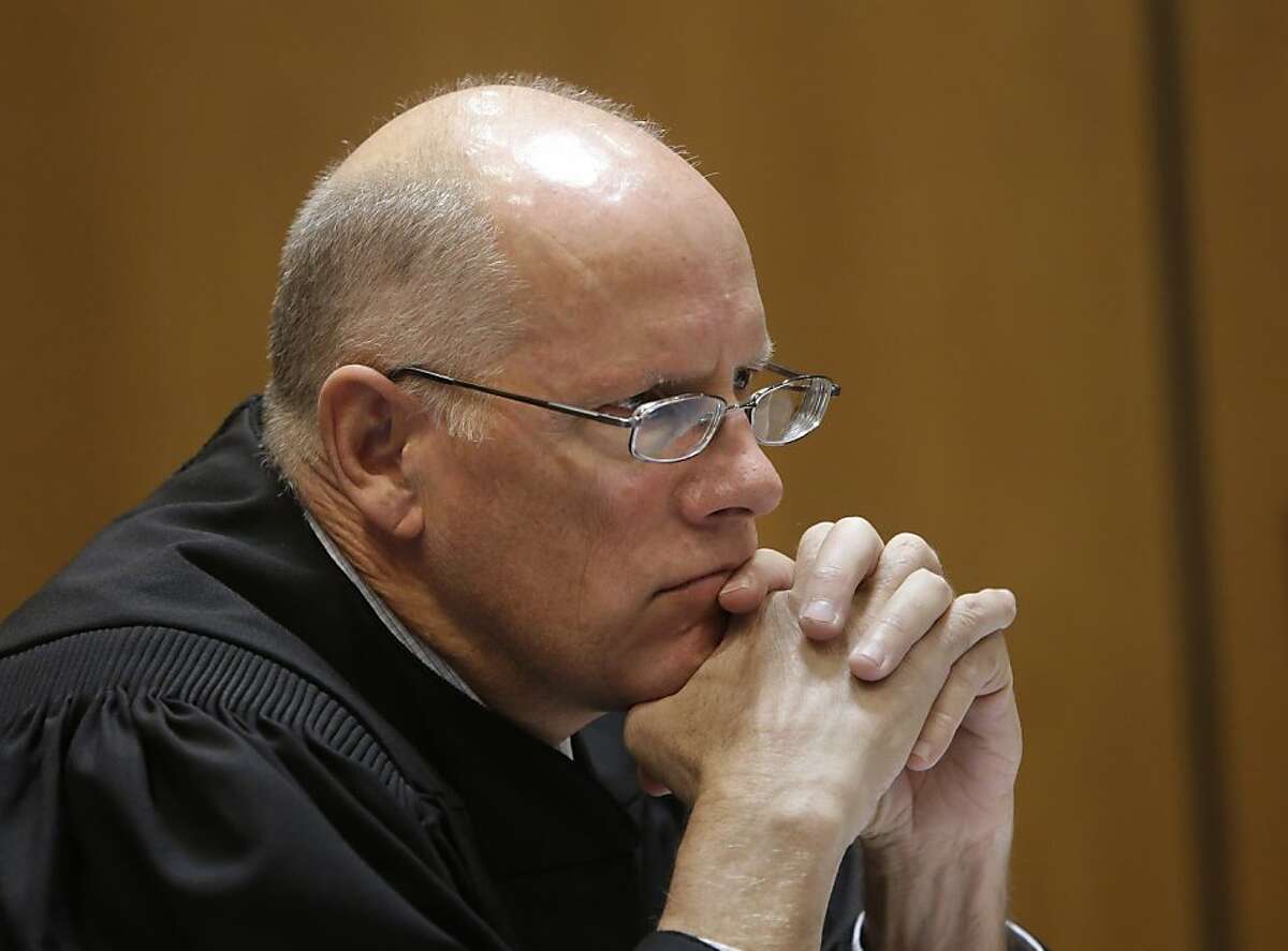 In this photo taken Nov. 8, 2013, Sacramento County Superior Court Judge Michael Kenny listens to arguments concerning a lawsuit to halt funding for California's high-speed rail on the grounds that the project violated the promises made to voters, in Sacramento County Superior Court, in Sacramento, Calif. In rulings issued Monday, Nov. 25, 2013, Kenny rejected a request from the California High-Speed Rail Authority to sell $8 billion of the $10 billion in bonds approved by voters in 2008. In a separate suit he also ordered the rail authority to redo its $68 billion funding plan before continuing construction. (AP Photo/Rich Pedroncelli)