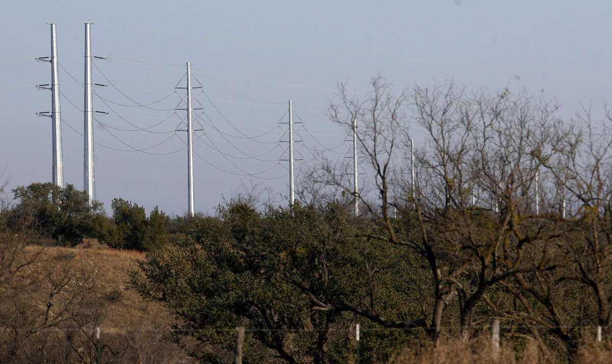 Giant electric transmission lines tower over the landscape near Menard. Texas manufacturers have come out against the state adopting what is called a capacity market.