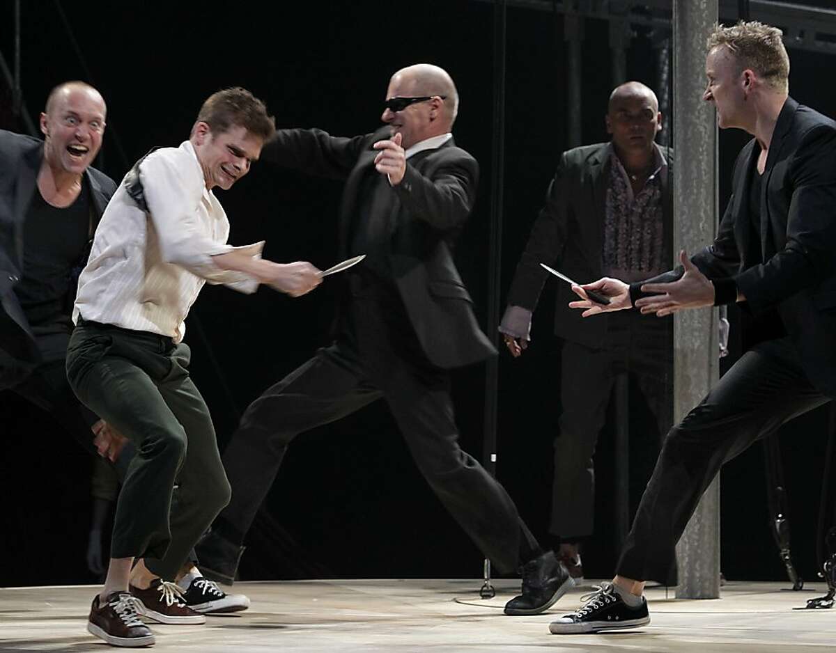 Tristan (in white shirt), portrayed by Andrew Durand, fends off King Mark (center), portrayed by Mike Shepherd, in the Berkeley Rep's presentation of Tristan & Yseult in Berkeley, Calif. on Friday, Nov. 22, 2013.