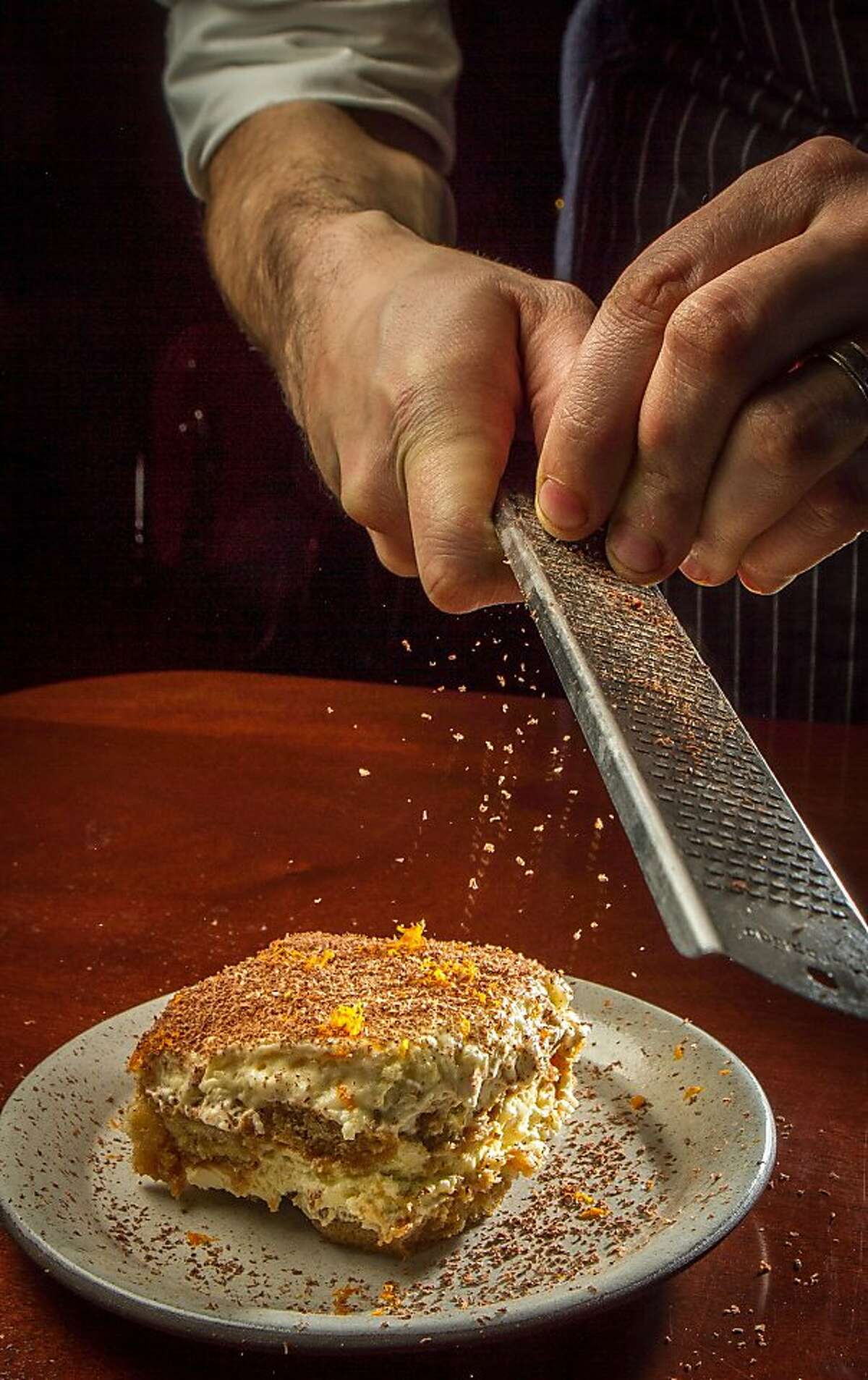 Chocolate being grated over Tiramisu at Tosca in San Francisco, Calif., is seen on November, 21st, 2013.
