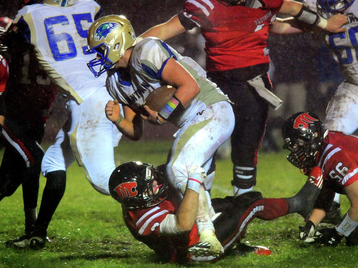 Masuk's Peter Kokkoros stops Newtown's Cooper Gold just short of the endzone, during football football action in Monroe, Conn. on Tuesday November 26, 2013. Gold scored a touchdown on the next play.
