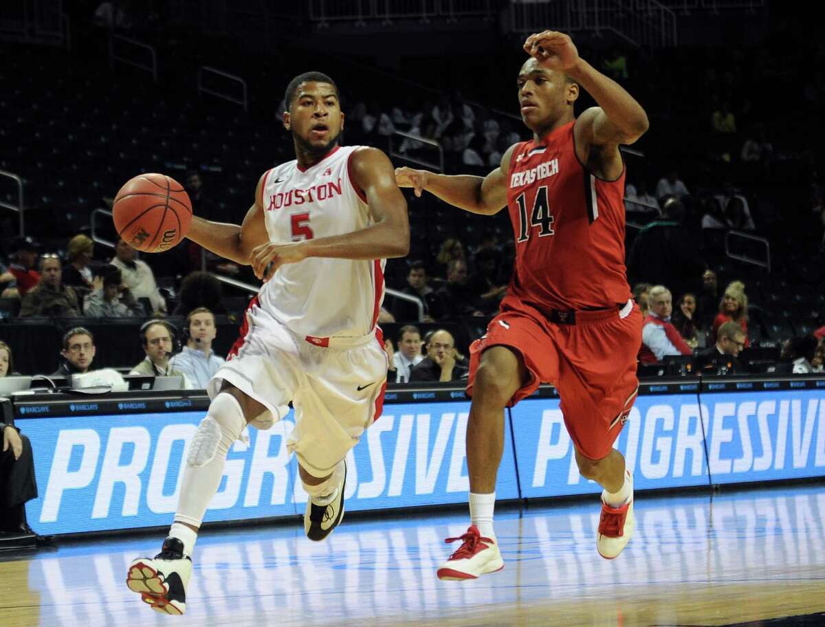 NEW YORK, NY - NOVEMBER 26: L.J. Rose #5 of the Houston Cougars drives past Robert Turner #14 of the Texas Tech Red Raiders during the second half at Barclays Center on November 26, 2013 in the Brooklyn borough of New York City.
