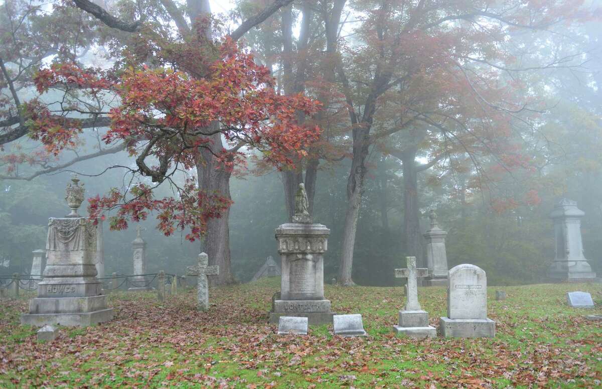 Early morning fog blankets the graves of Albany Rural Cemetery Thursday, Oct. 10, 2013, in Menands, N.Y. (Will Waldron/Times Union)