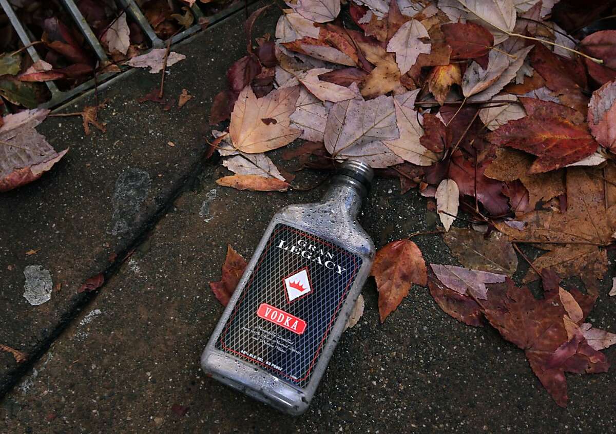 An empty vodka bottle is left in the gutter on 4th Street in downtown San Rafael, Calif. on Wednesday, Nov. 20, 2013. A recent uptick in the transient homeless population has frustrated downtown merchants.