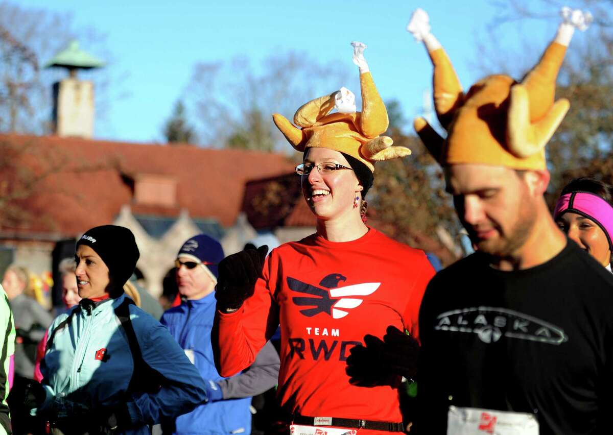 Laura Henry, of Baldwinsville, NY, wears her turkey hat as she runs in the annual Pequot Road Runners Thanksgiving Day 5 Mile Road Race Thursday, Nov. 28, 2013 in Southport, Conn.