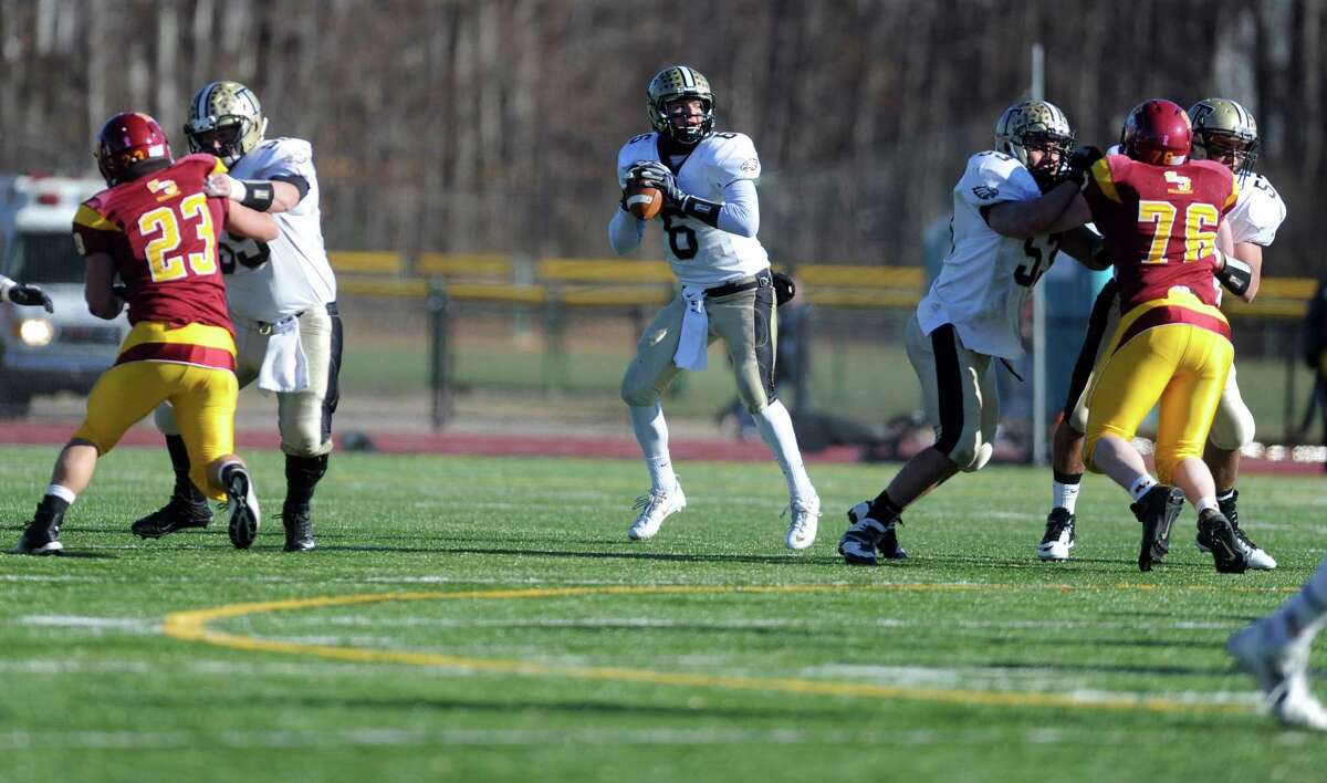 Trumbull's Jeff Sam looks to pass the ball during the annual Thanksgiving Day football game against St. Joseph Thursday, Nov. 28, 2013 at St. Joseph High School in Trumbull, Conn.